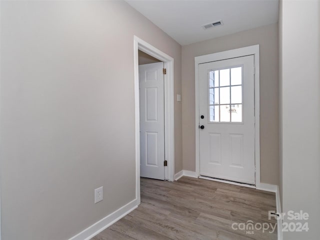 doorway with light wood-type flooring