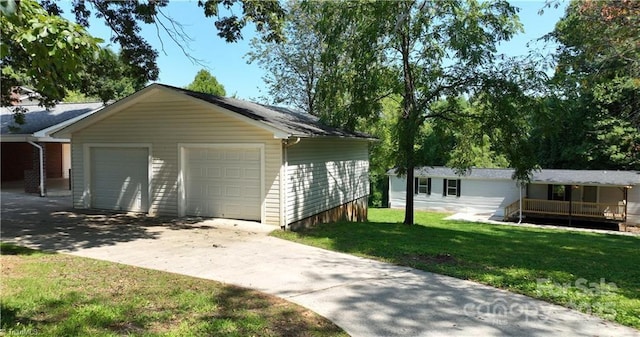 view of front facade featuring a garage, an outdoor structure, and a front yard