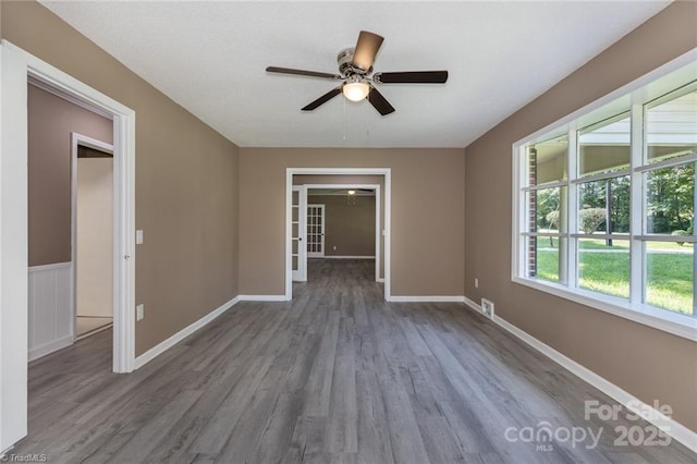 empty room featuring ceiling fan and hardwood / wood-style flooring