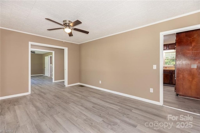 spare room with light hardwood / wood-style floors, ceiling fan, and ornamental molding