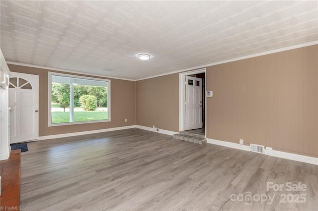 unfurnished room with wood-type flooring and ornamental molding