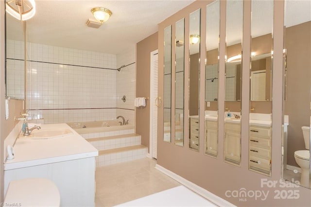 bathroom with tile patterned flooring, vanity, and toilet