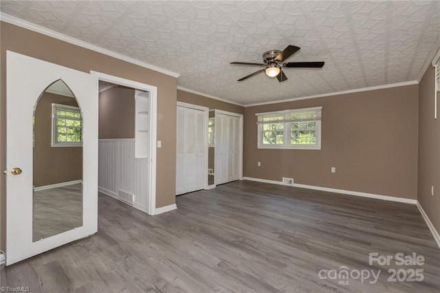 unfurnished room with ceiling fan, crown molding, and wood-type flooring