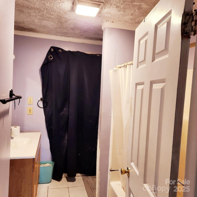 bathroom with vanity, tile patterned flooring, and a textured ceiling