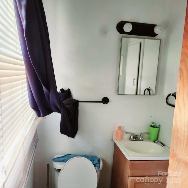 bathroom featuring vanity and toilet