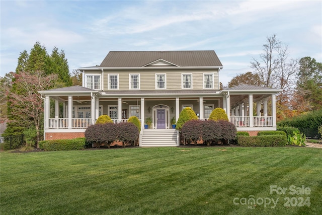 farmhouse featuring a front yard and covered porch