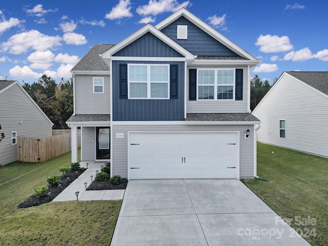 view of front of home featuring a front yard and a garage