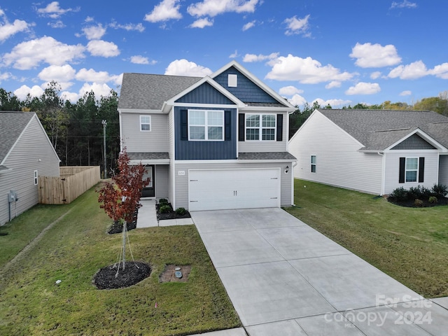 view of front of property featuring a garage and a front lawn