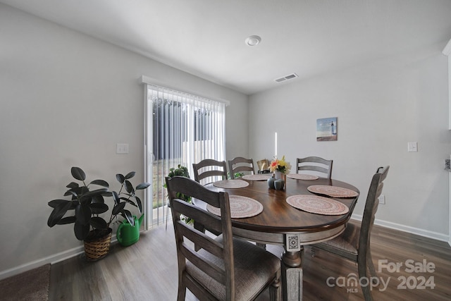 dining space featuring dark hardwood / wood-style floors