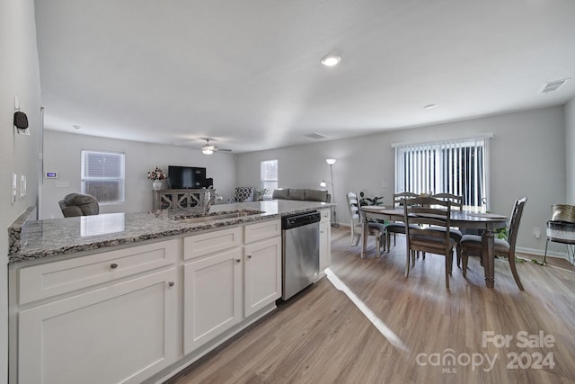 kitchen with dishwasher, white cabinetry, sink, and light hardwood / wood-style flooring