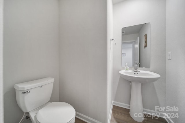 bathroom featuring hardwood / wood-style floors and toilet