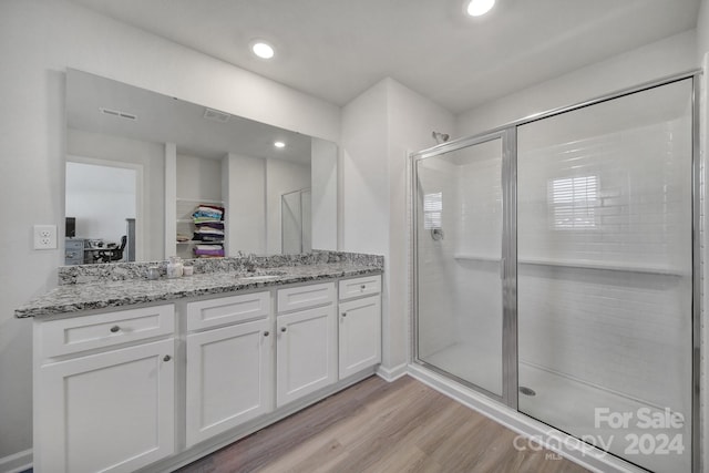 bathroom featuring vanity, hardwood / wood-style flooring, and an enclosed shower