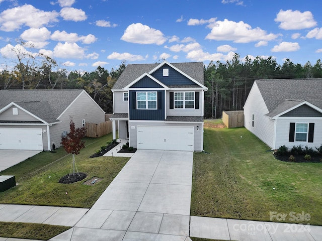 view of front of property featuring a front yard and a garage