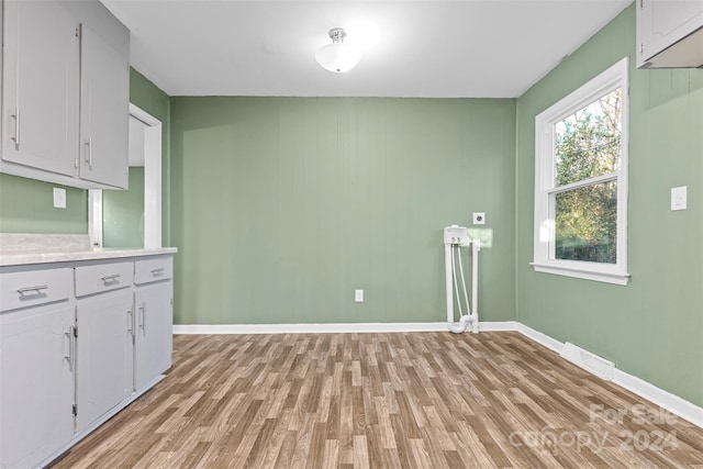 kitchen with white cabinets and light wood-type flooring