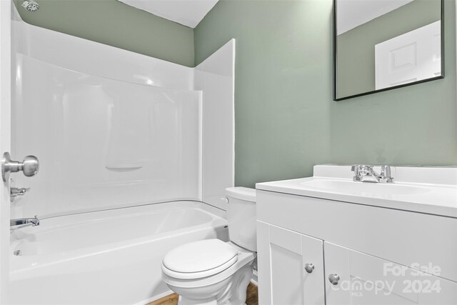 full bathroom with toilet, vanity, and tub / shower combination