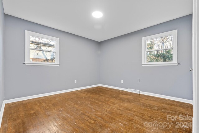 spare room with hardwood / wood-style flooring