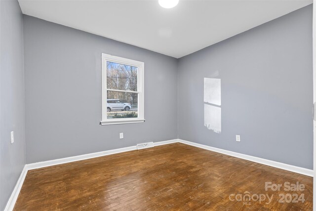 unfurnished room featuring hardwood / wood-style flooring