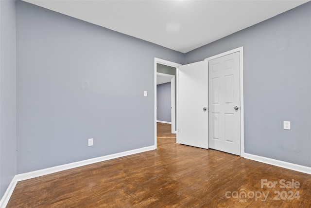 unfurnished bedroom with hardwood / wood-style flooring