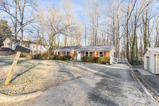 ranch-style house with a garage and a front lawn