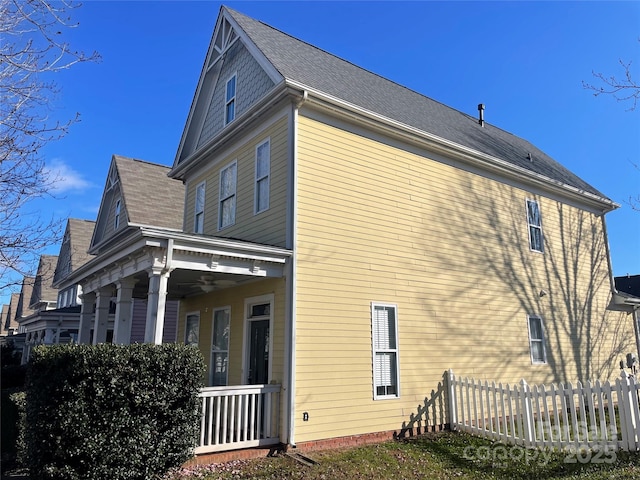 view of property exterior with ceiling fan and covered porch