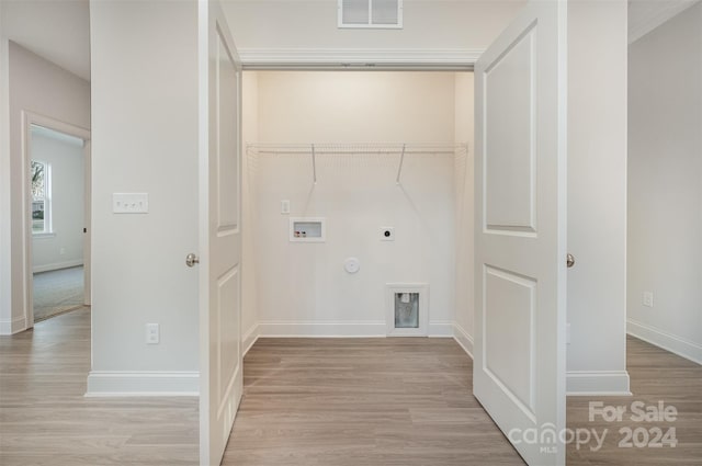 washroom with electric dryer hookup, gas dryer hookup, hookup for a washing machine, and light hardwood / wood-style flooring