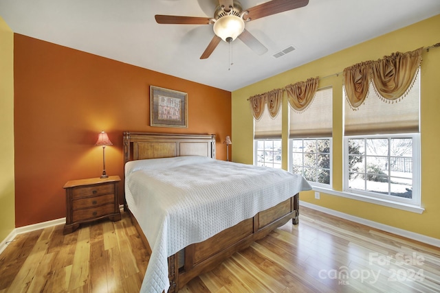 bedroom with light hardwood / wood-style floors and ceiling fan