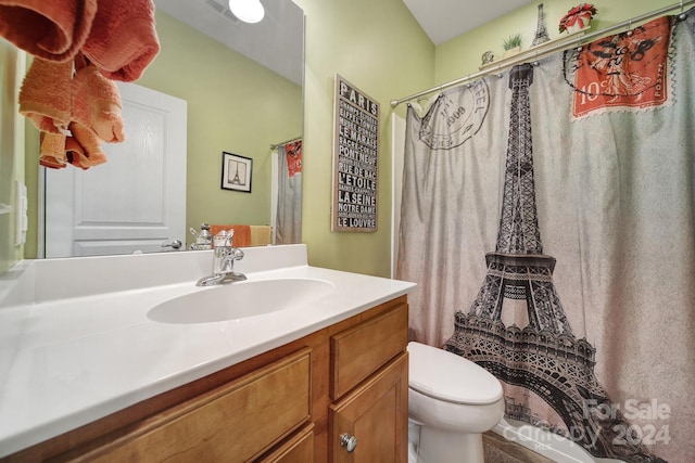 bathroom with vanity, toilet, and walk in shower