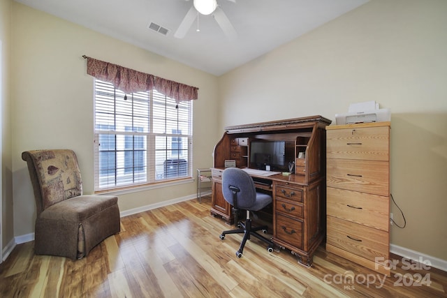 office with light hardwood / wood-style flooring and ceiling fan