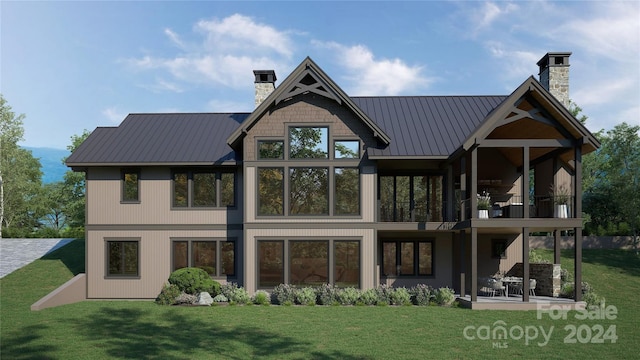 rear view of house with a patio area, a balcony, and a yard