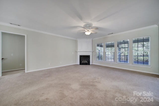 unfurnished living room featuring a fireplace, light colored carpet, and ornamental molding