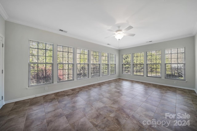 tiled empty room featuring ceiling fan and crown molding