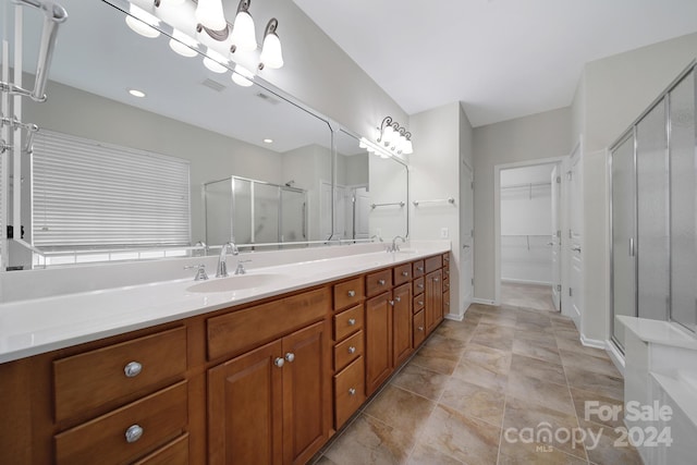 bathroom with vanity and a shower with shower door