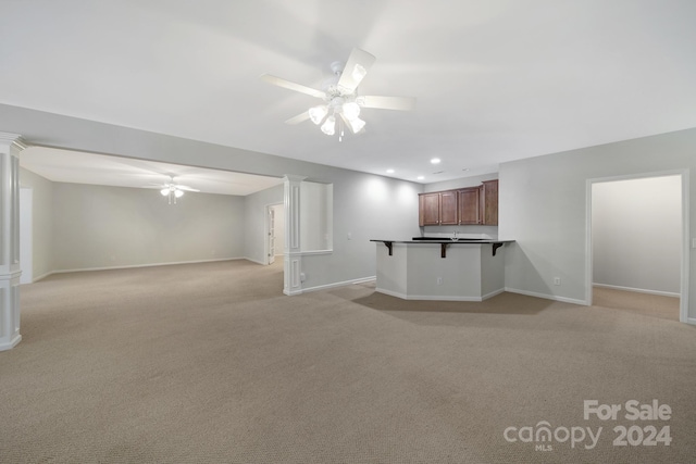 basement with light carpet and ceiling fan