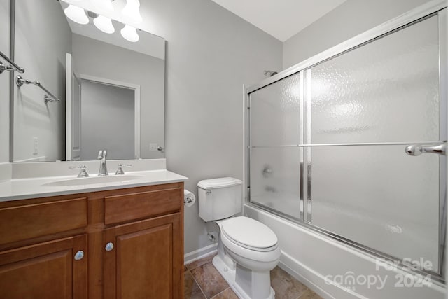 full bathroom with toilet, vanity, tile patterned floors, and enclosed tub / shower combo