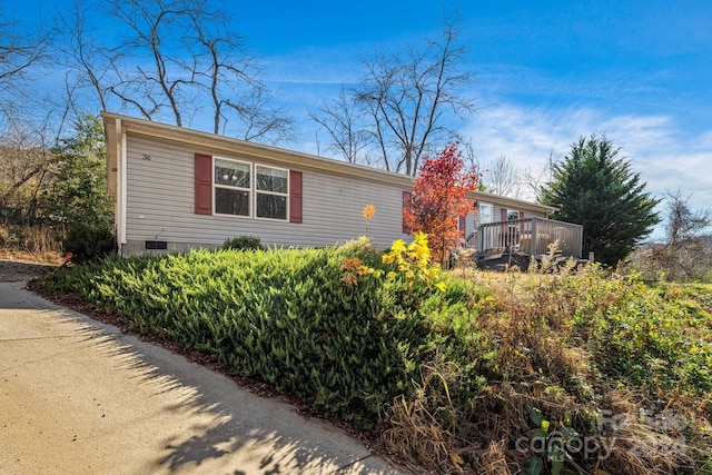 view of property exterior featuring a deck