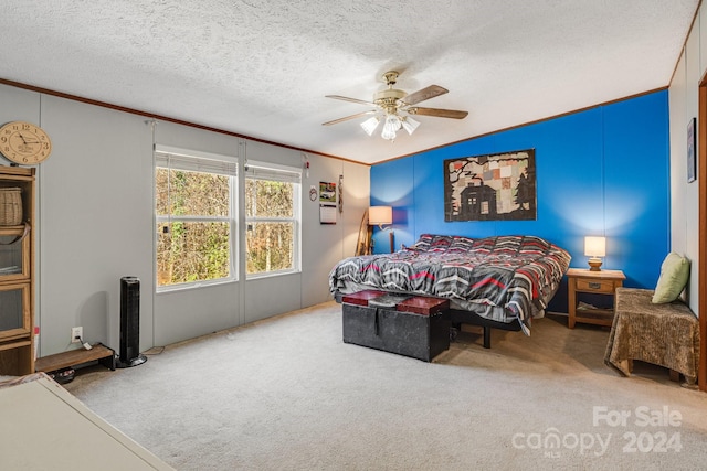 carpeted bedroom with ceiling fan, ornamental molding, and a textured ceiling