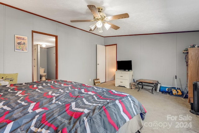 carpeted bedroom featuring ceiling fan, ornamental molding, a textured ceiling, and connected bathroom