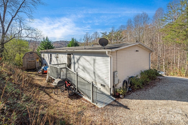 view of property exterior featuring a storage unit