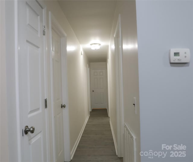 corridor featuring dark hardwood / wood-style flooring