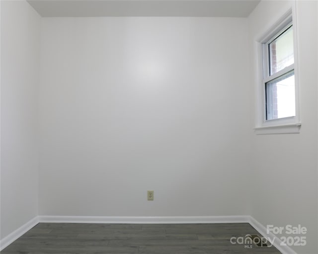 unfurnished room featuring dark hardwood / wood-style flooring