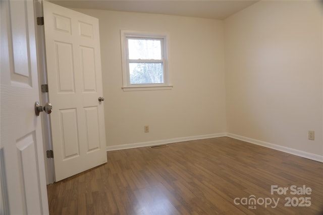 spare room featuring dark hardwood / wood-style floors