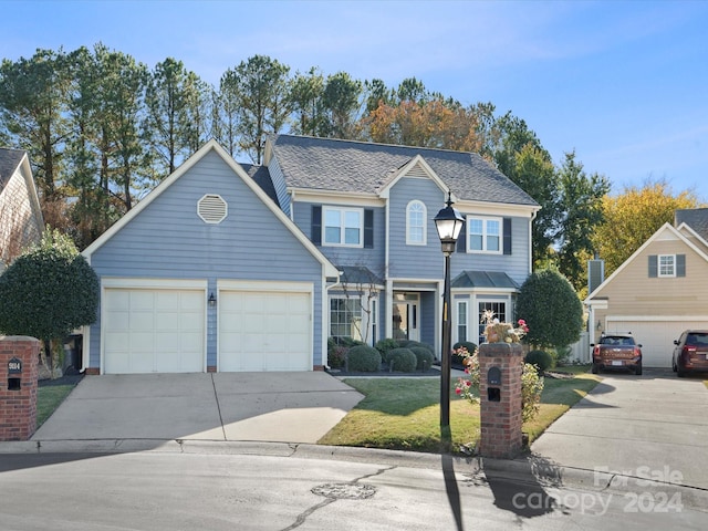 view of front property with a front yard and a garage