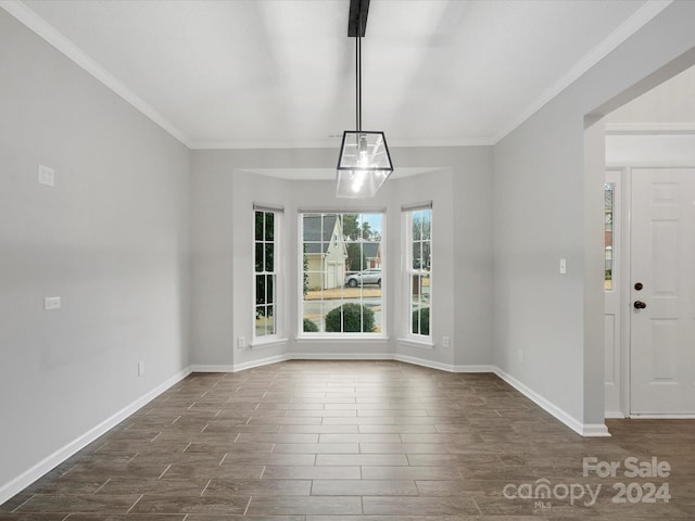 unfurnished dining area with dark hardwood / wood-style flooring and ornamental molding