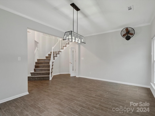 interior space featuring ornamental molding and dark wood-type flooring