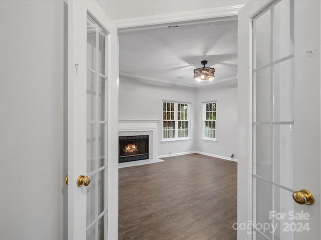 unfurnished living room with hardwood / wood-style floors and a textured ceiling