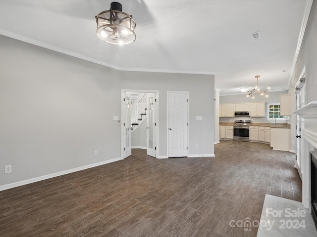 unfurnished living room with a chandelier, dark hardwood / wood-style floors, and crown molding