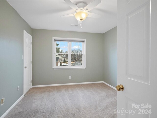 carpeted empty room with ceiling fan