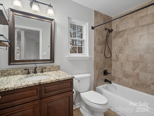 full bathroom featuring vanity, toilet, and tiled shower / bath