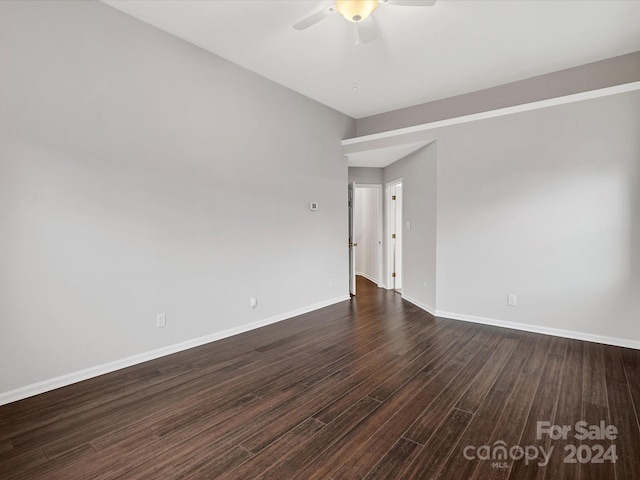 spare room with dark hardwood / wood-style floors and ceiling fan