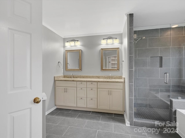 bathroom with tile patterned flooring, vanity, a shower with shower door, and crown molding